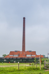 Fototapeta na wymiar Old restored Dutch stone factory along the river Rhine in Wageningen in the Netherlands