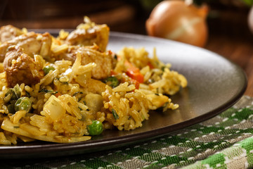 Fried rice nasi goreng with chicken and vegetables on a plate