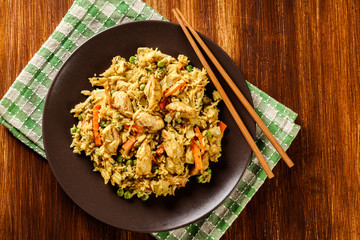 Fried rice nasi goreng with chicken and vegetables on a plate