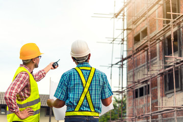 Two young man architect on a building construction site