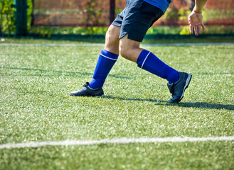 Fototapeta na wymiar Legs of football players in action