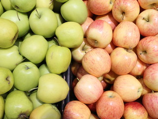 green and red apples in a box