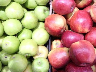 green and red apples in a box