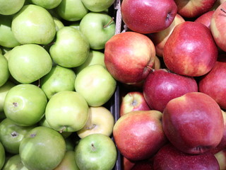 green and red apples in a box