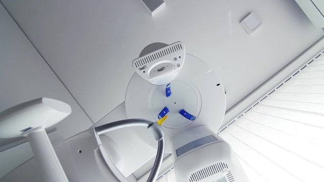 Modern panoramic rotating digital X-ray machine at dentist office. Dental clinic equipment. Bottom view.