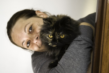 Woman hugging cat