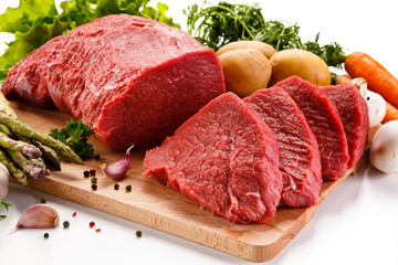 Raw beef on cutting board on white background