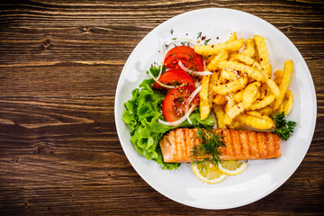 Fried salmon, chips and vegetables