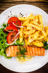 Fried salmon, chips and vegetables