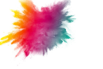 Multi color powder explosion on white background. Bizarre forms of  colorful dust particles splash on dark background.