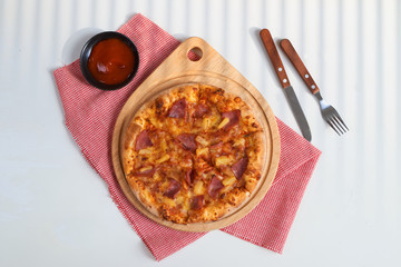 Pizza with cheese and pizza paddle on wooden table background