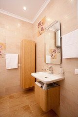 epmty minimalistic interior background, bathroom of modern apartment, mirror and basin in light colors