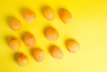 Ripe beautiful apricots lie on a yellow background. The concept of proper and healthy nutrition. Dietary food