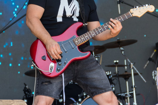 Guitarist  play electricity guitar on concert stage