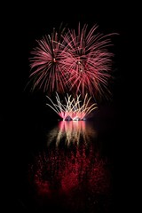 Beautiful colorful fireworks with reflections in water. Brno dam, the city of Brno-Europe. International Fireworks Competition.