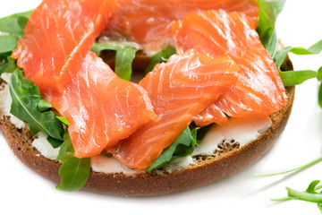 close-up view of bagel sandwich with salmon isolated on white background