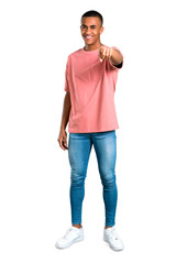 Fototapeta premium Standing young african american man points finger at you with a confident expression on isolated white background