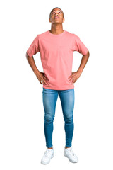 Standing young african american man stand and looking up on isolated white background