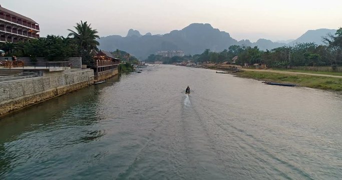 Aerial view footage of boat in Vang Vieng, Laos.