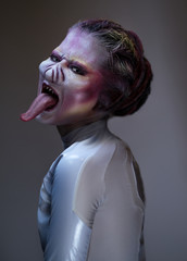 Portrait of female alien monster showing tongue
