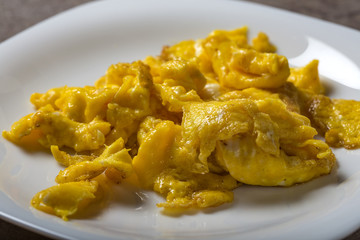 Scrambled eggs on a white plate