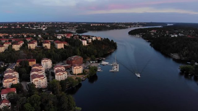Aerial footage of the Stockholm island Stora Essingen and its western shore at dusk