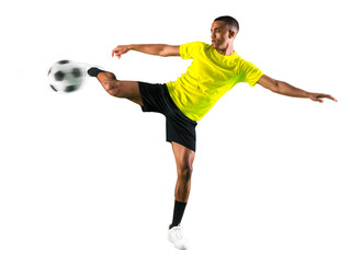 Soccer player man with dark skinned playing kicking the ball