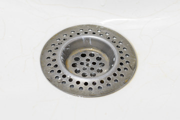 Hole in a kitchen sink. Selective focus.