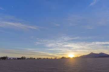 Sunrise over barren sandy area
