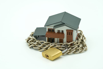 Model house wrapped with steel chain and padlock. Ideas Security. using as background business concept and Security concept with copy space.