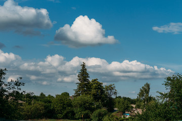 Cumulus clouds over a village in the Black Forest.