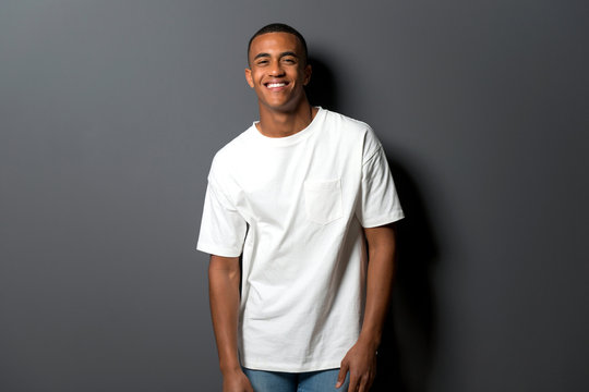 Happy young african american man on grey wall background