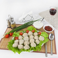 Kinkali in green with tomatoes and onions. Serve with soy sauce and sour cream.