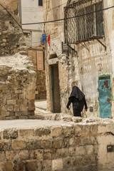 Acre, Israel - May 10, 2018 : Muslim woman walking in old Acre