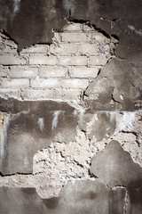Old gray brick and plaster wall texture background