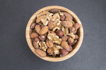 bowl filled with nuts such as almonds, walnuts and hazelnuts