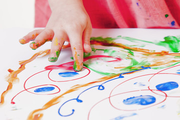 Naklejka premium Great artist. Close up of little child girl painting a picture (talent, art, creativity concept)
