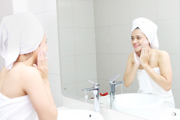 Asian woman washing her face with a soap