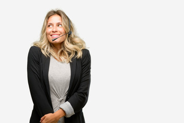 Young woman operator from call center thinking and looking up expressing doubt and wonder