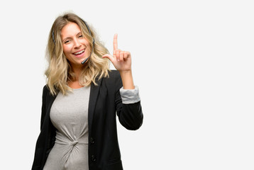 Young woman operator from call center pointing away side with finger