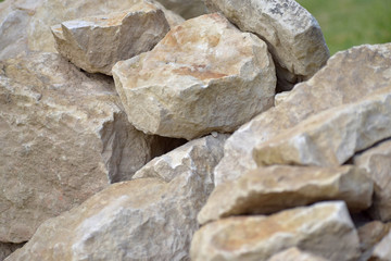 Building material stone. The light stone is straightened in a pile.