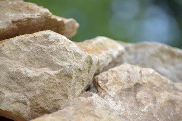 Building material stone. The light stone is straightened in a pile.