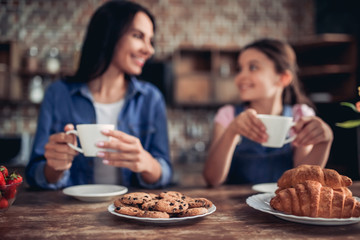 mother and daughter drinking tea