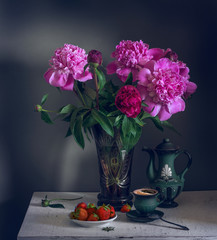 still life with flowers, strawberries and a cup of coffee. a bouquet of peonies. vintage.