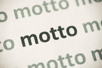 word motto printed on paper macro