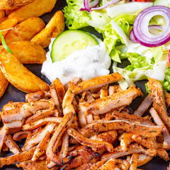Rustic gyros plate it green salad and potato wedges