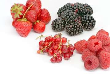 assorted ripe forest berries on white with copy space
