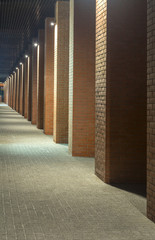 Night view. Industrial building. Office buildings in loft style. Long corridor. Red brick house. Evening
