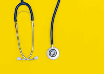 Top view blue stethoscope on yellow background, For check heart or health check up concept