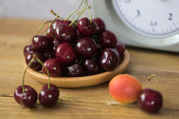Cherries on a wooden plate